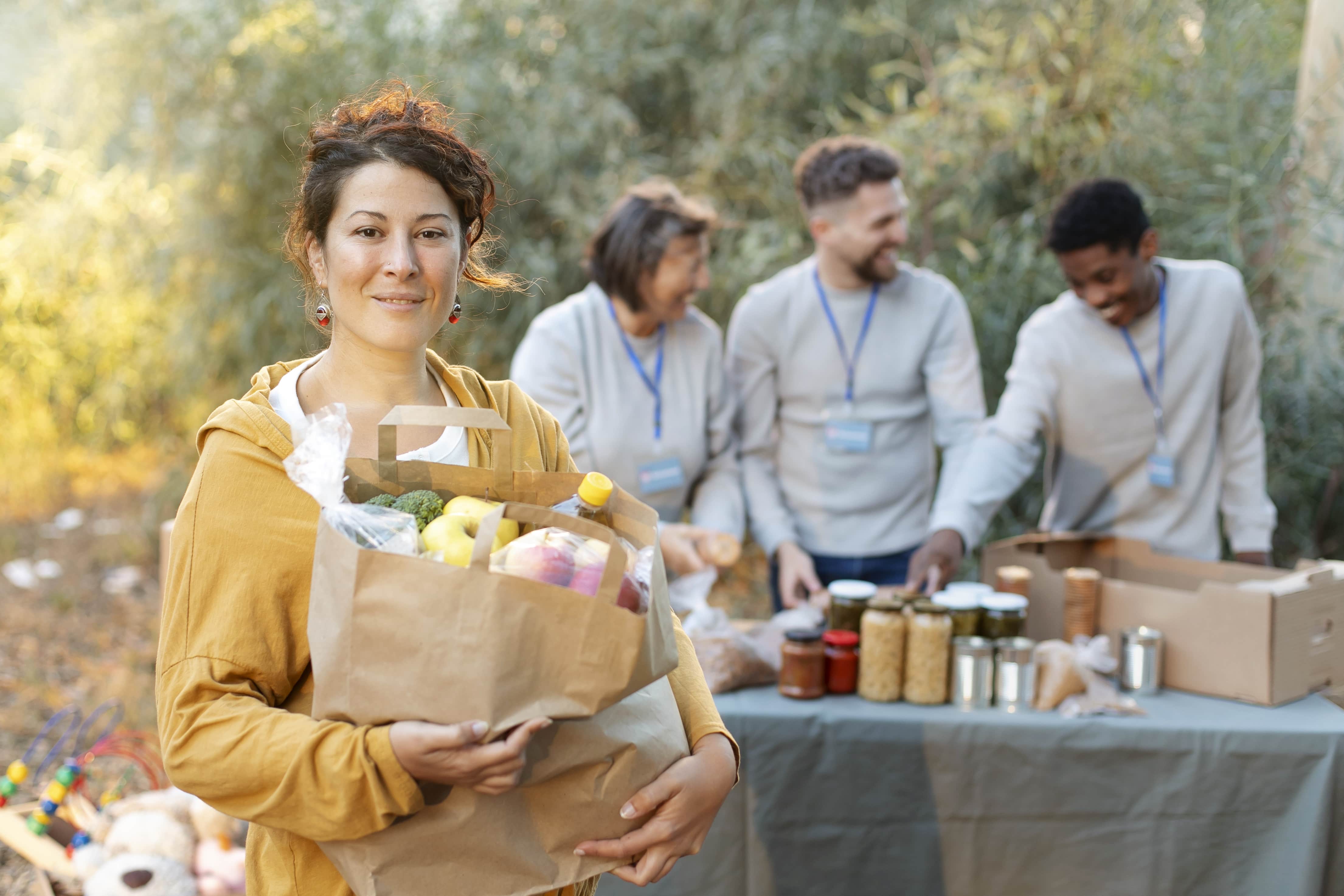 medium-shot-volunteers-with-food-donations